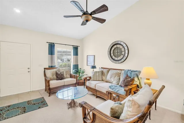 a living room with furniture a clock and a rug