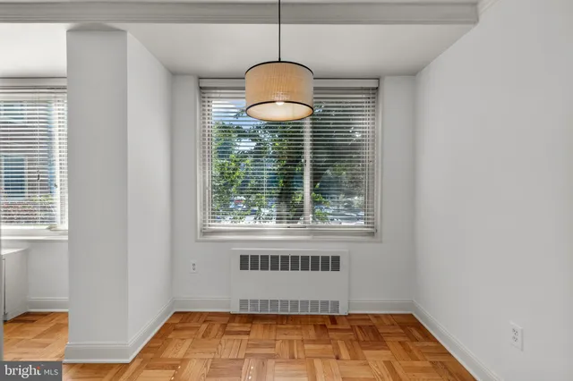 a bathroom with a window and a shower
