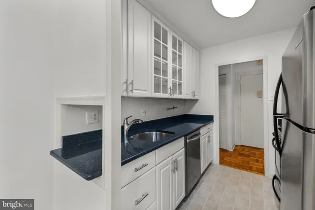 a kitchen with stainless steel appliances granite countertop a refrigerator and a sink