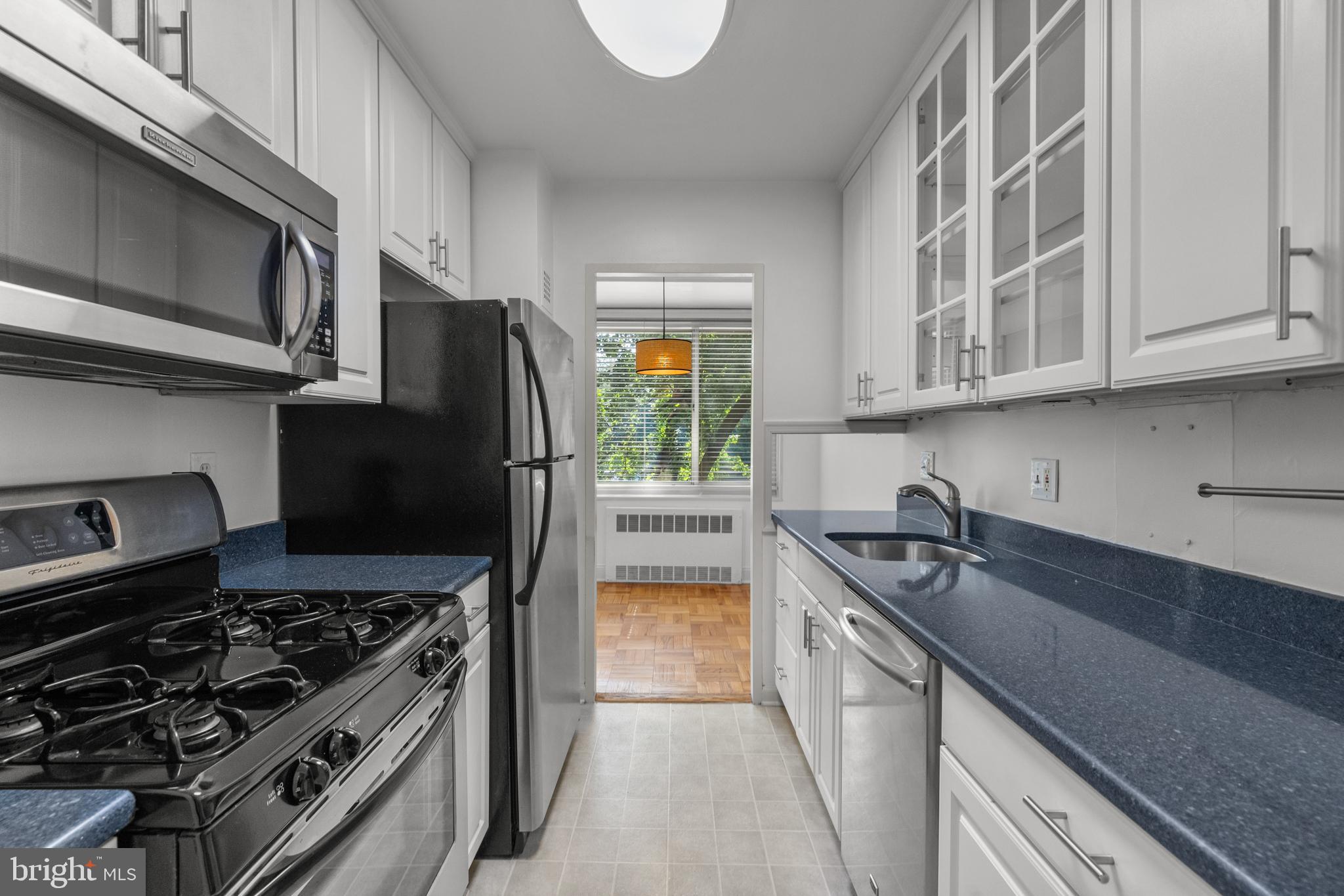 4000 Tunlaw Road Northwest, Unit 220 Washington, DC 20007 - Photo 17 of 33 a kitchen with a sink stove and refrigerator