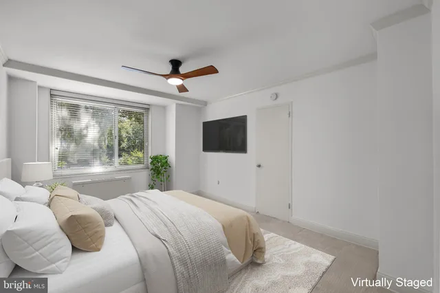 a bedroom with a large bed and a flat screen tv