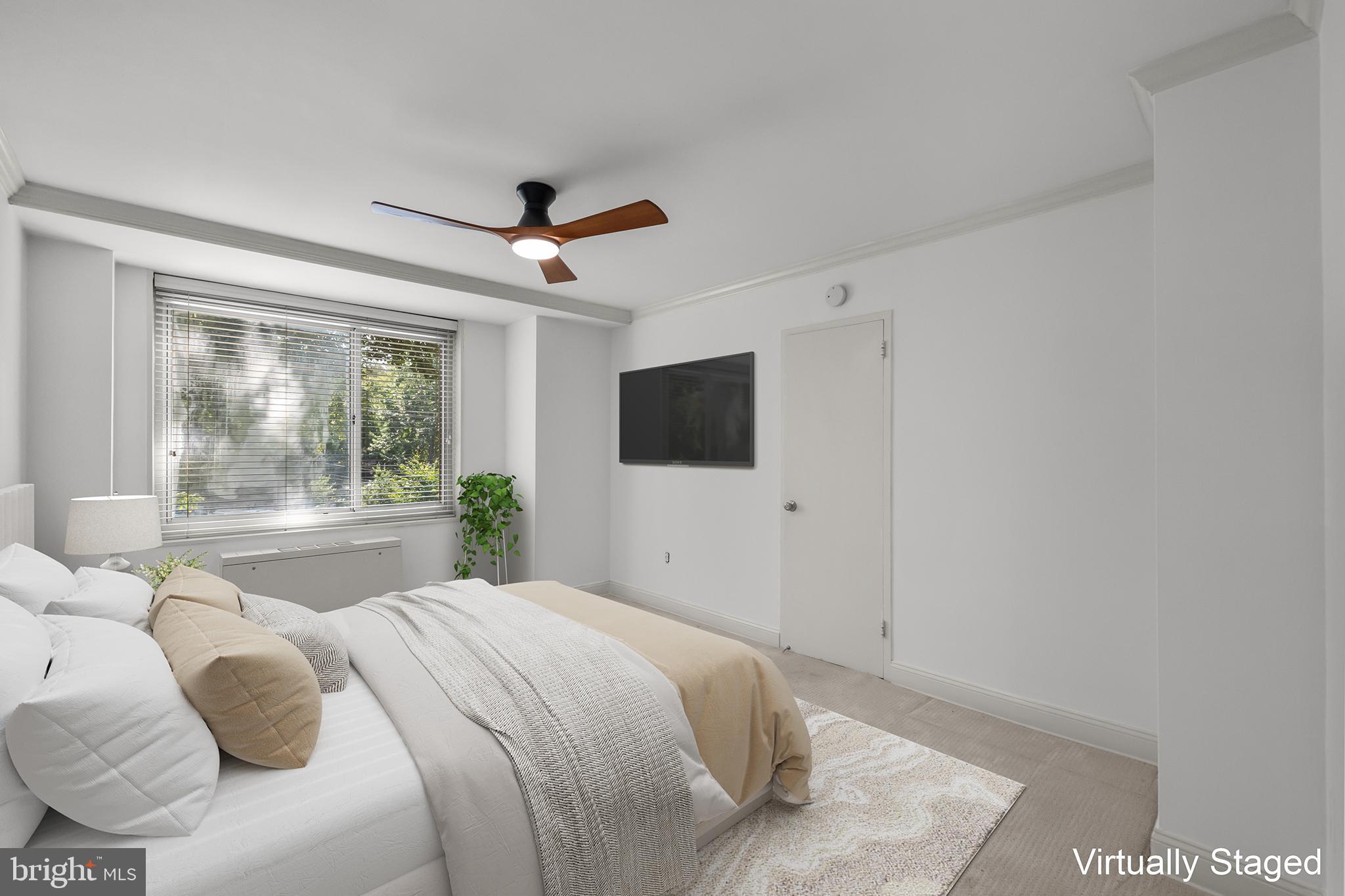4000 Tunlaw Road Northwest, Unit 220 Washington, DC 20007 - Photo 19 of 33 a bedroom with a large bed and a flat screen tv