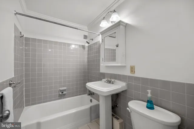 a bathroom with a sink mirror toilet and bathtub