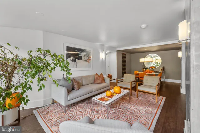 a living room with furniture and flowers