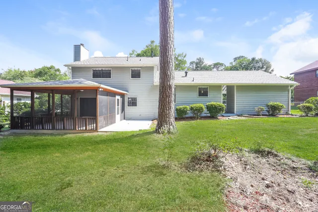 a front view of house with yard and green space
