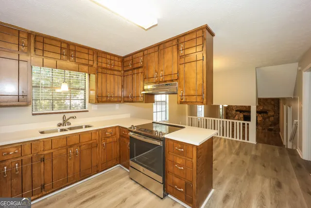 a kitchen that has a sink and a stove in it