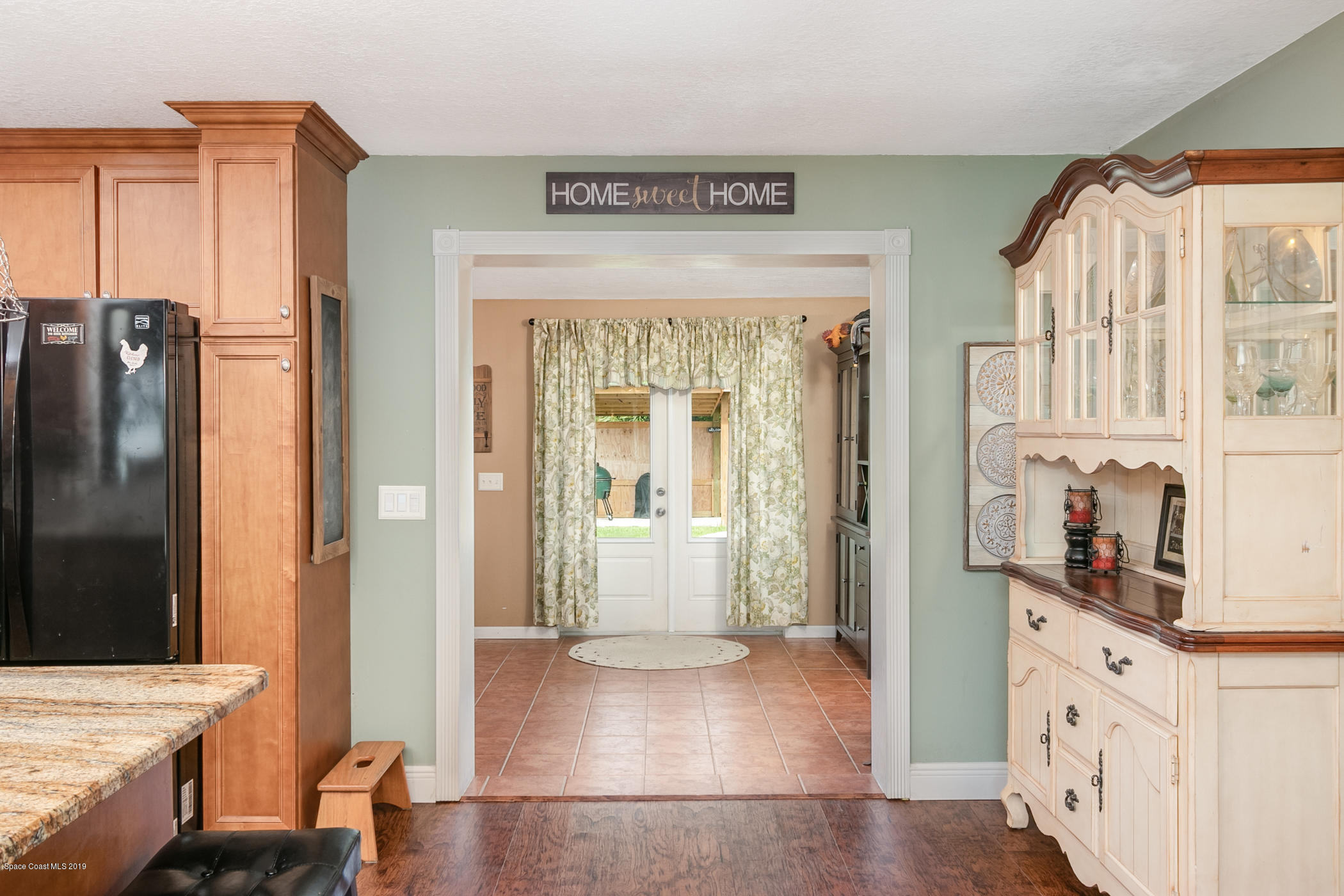1760 Corey Road Malabar, FL 32950 - Photo 11 of 39 a view of hallway with wooden floor and a living room