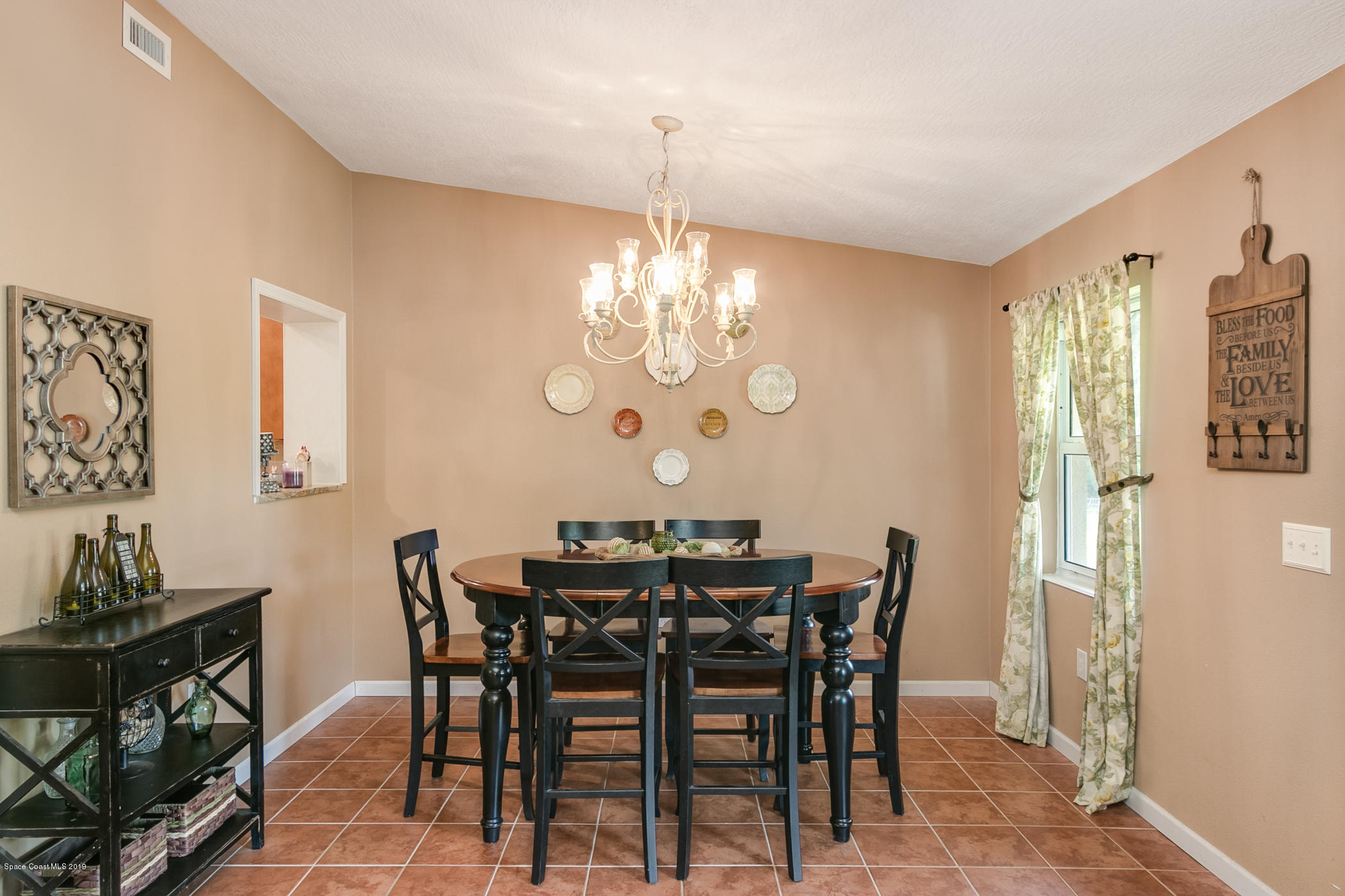 1760 Corey Road Malabar, FL 32950 - Photo 12 of 39 a view of a dining room with furniture and chandelier