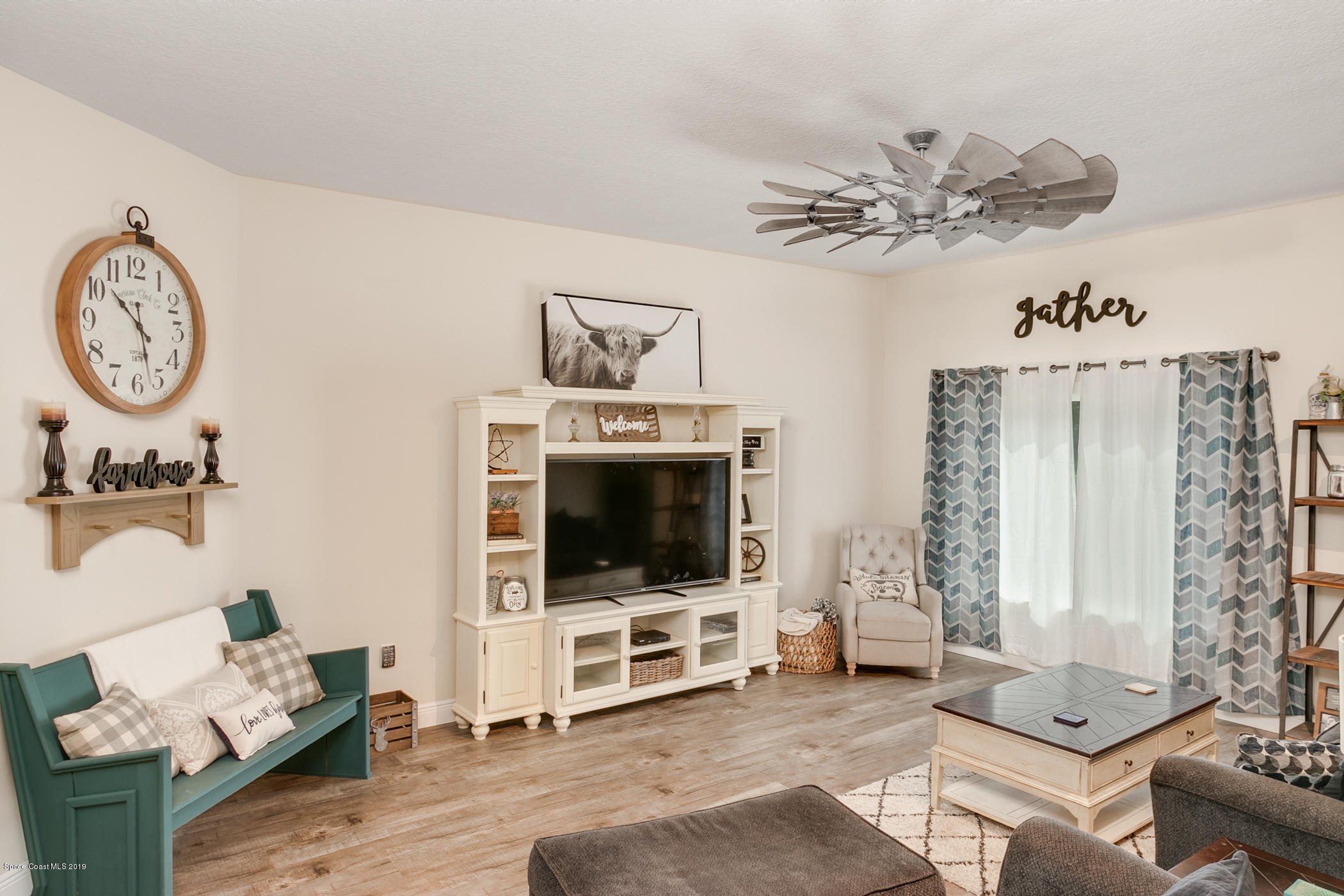 1760 Corey Road Malabar, FL 32950 - Photo 13 of 39 a living room with furniture and a flat screen tv