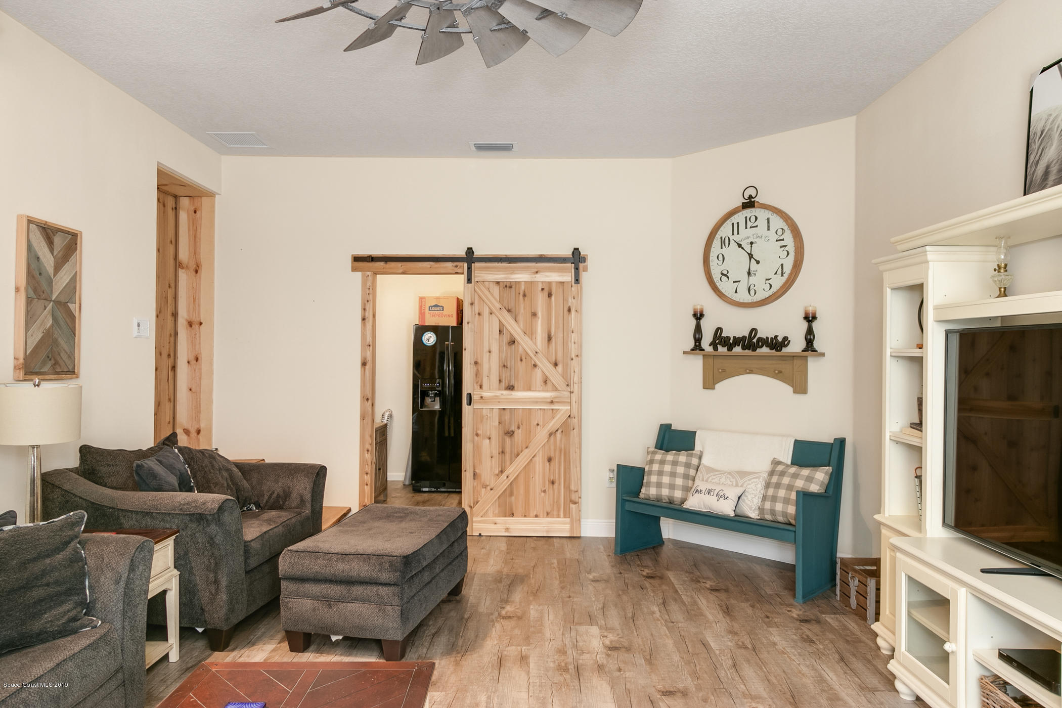1760 Corey Road Malabar, FL 32950 - Photo 14 of 39 a living room with furniture and a flat screen tv
