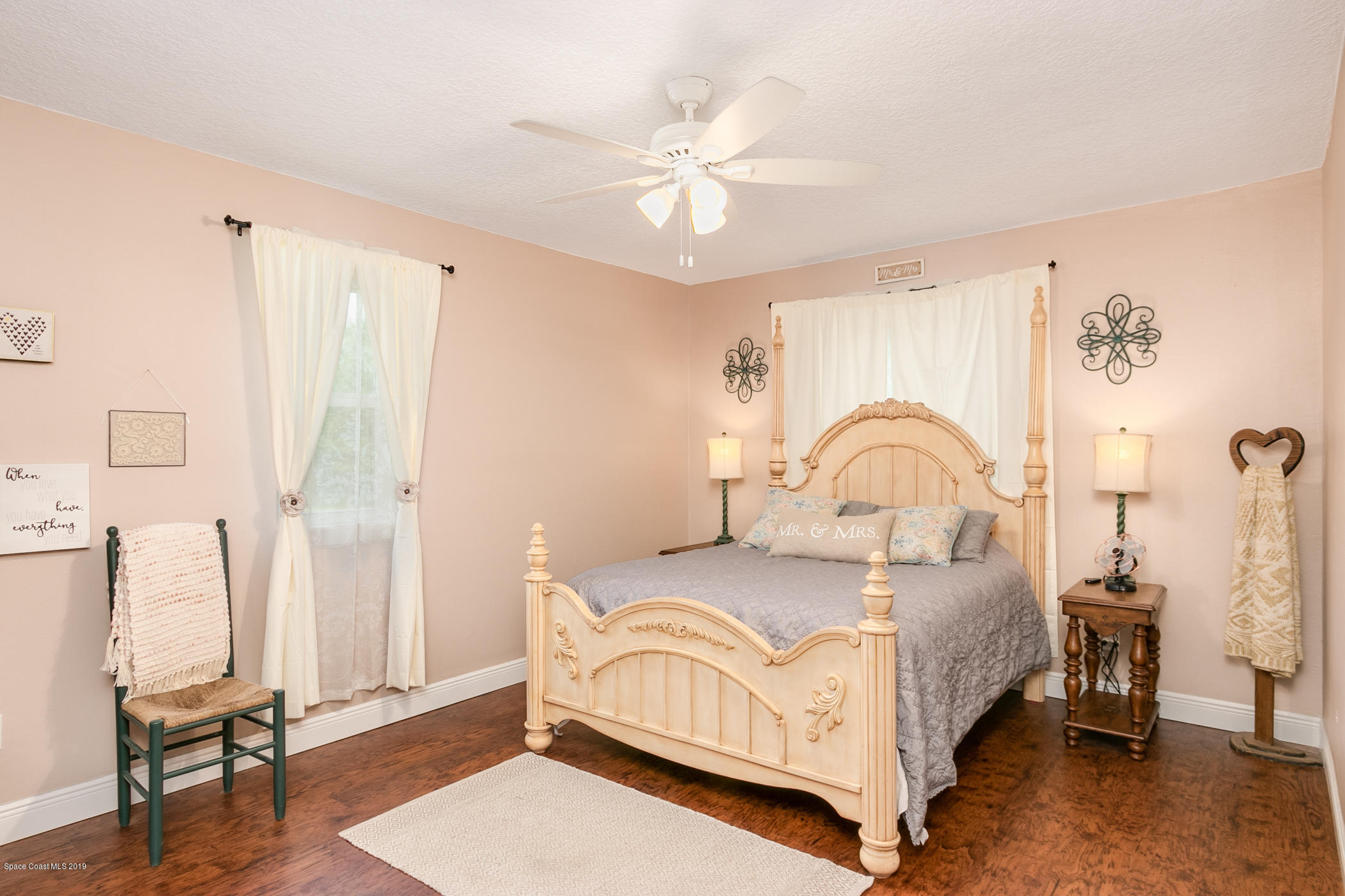 1760 Corey Road Malabar, FL 32950 - Photo 16 of 39 a bedroom with a bed and a chandelier