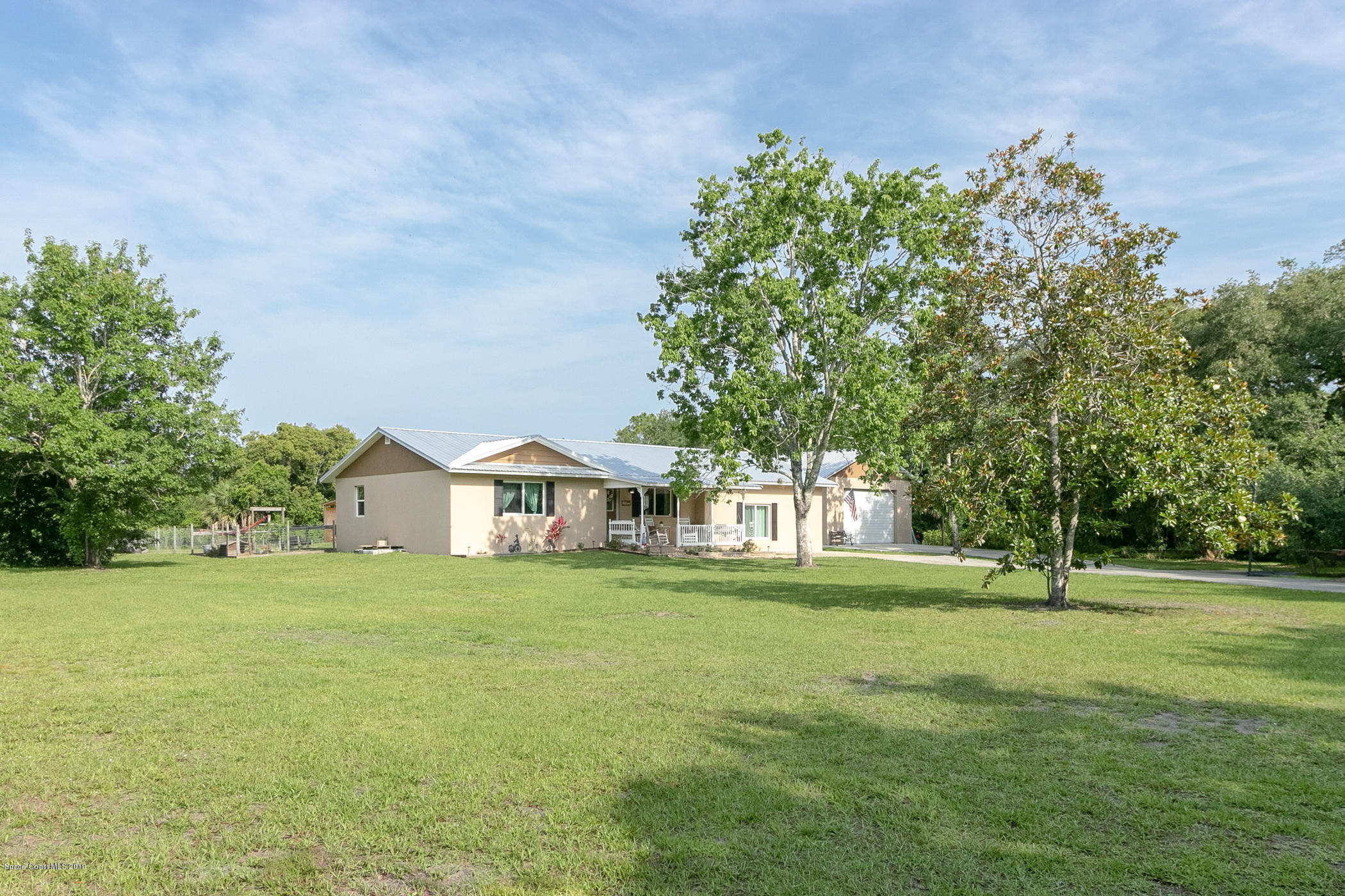 1760 Corey Road Malabar, FL 32950 - Photo 3 of 39 a front view of a house with a yard