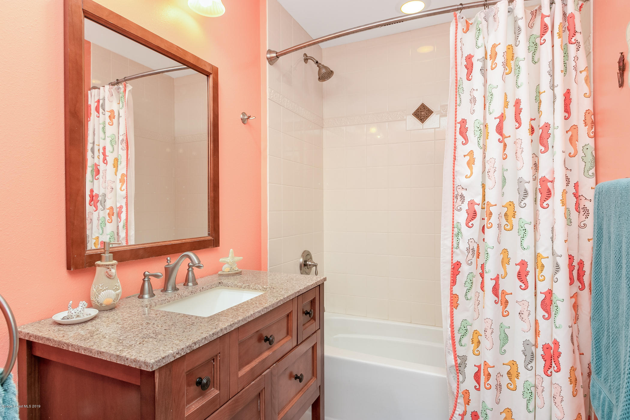 1760 Corey Road Malabar, FL 32950 - Photo 22 of 39 a bathroom with a granite countertop sink and a mirror