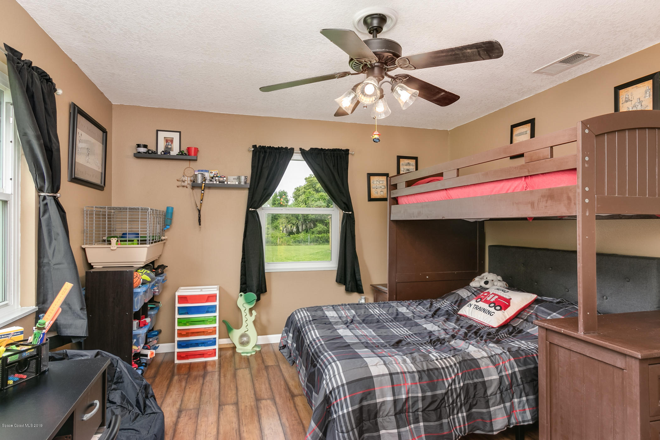 1760 Corey Road Malabar, FL 32950 - Photo 23 of 39 a bedroom with a bed and a chandelier
