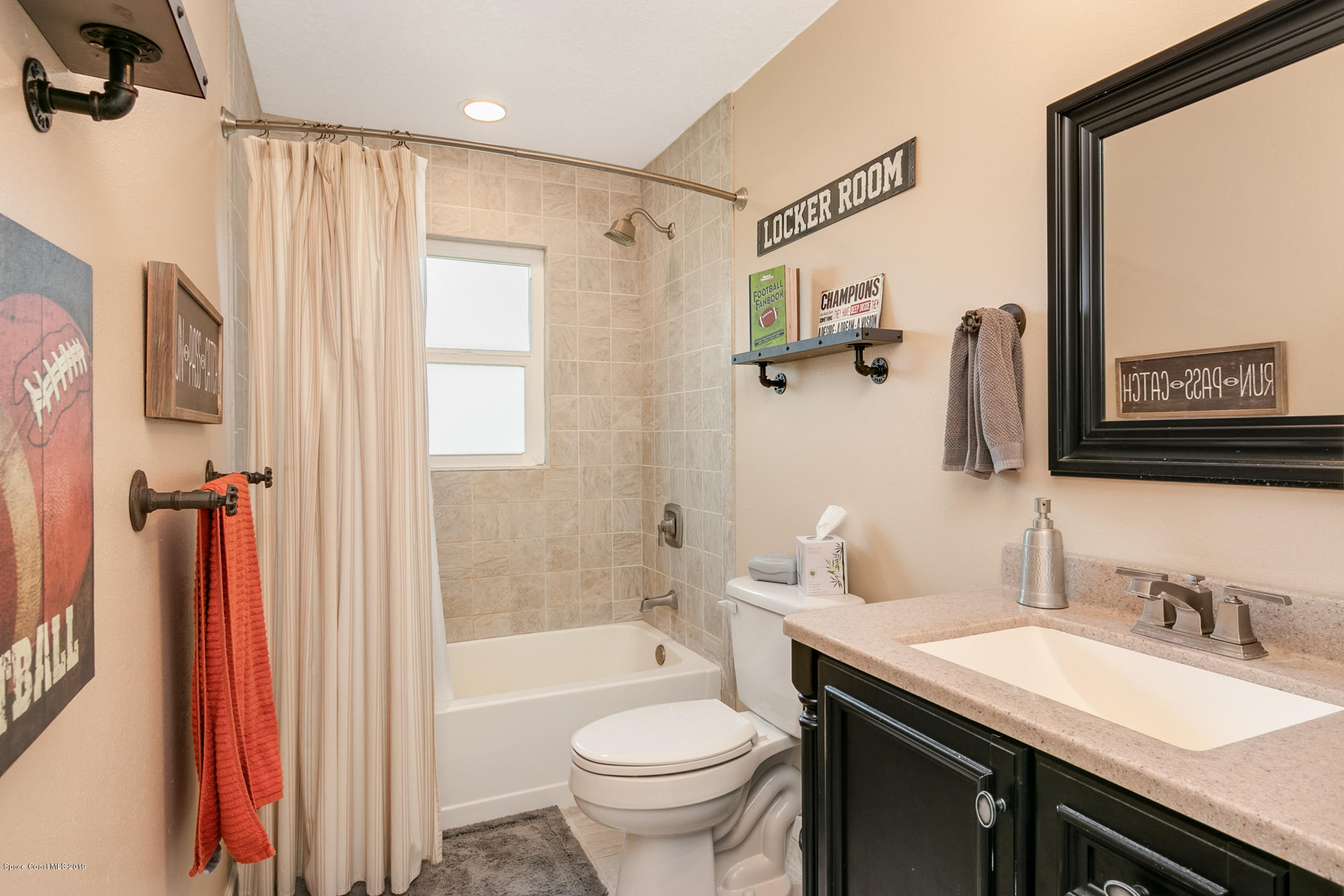 1760 Corey Road Malabar, FL 32950 - Photo 24 of 39 a bathroom with a granite countertop sink toilet and shower