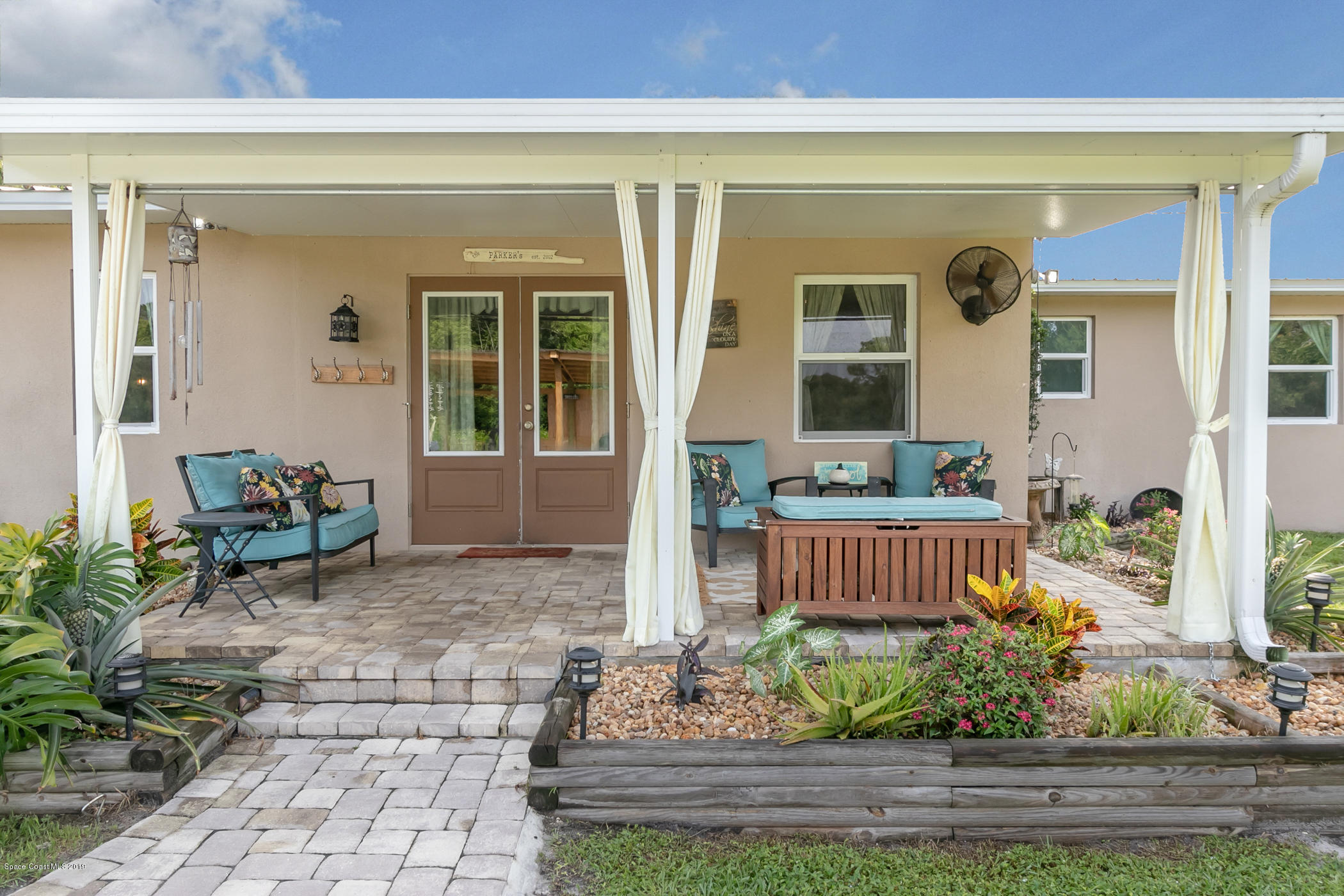 1760 Corey Road Malabar, FL 32950 - Photo 25 of 39 a view of a house with a wooden bench in a patio