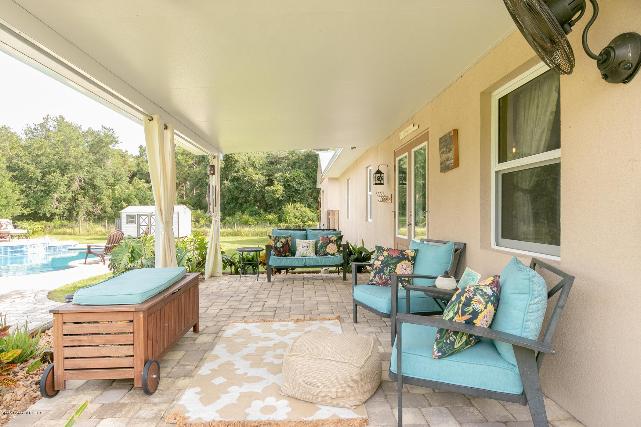 1760 Corey Road Malabar, FL 32950 - Photo 26 of 39 a building outdoor space with patio furniture and potted plants