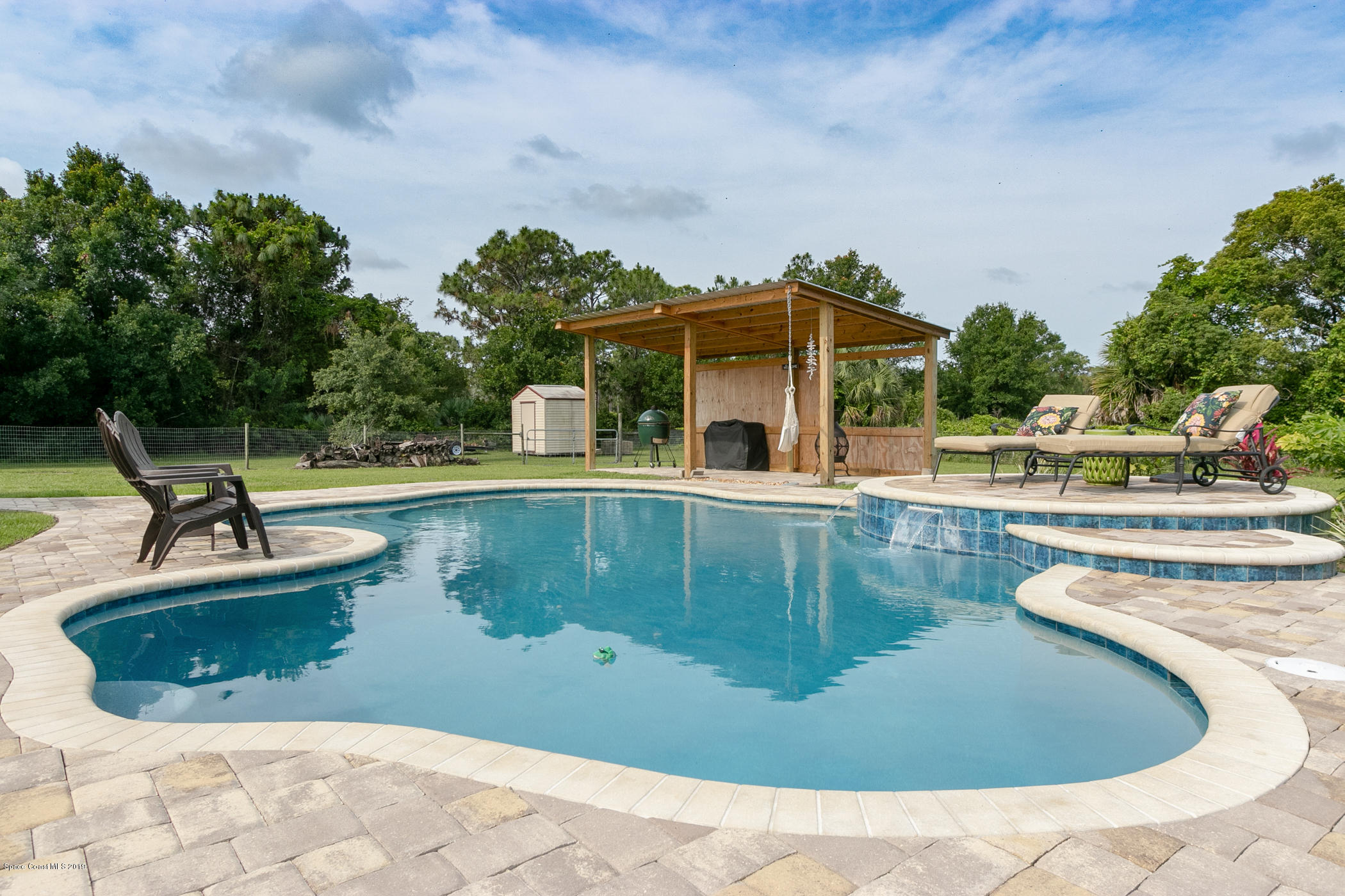 1760 Corey Road Malabar, FL 32950 - Photo 4 of 39 a view of a swimming pool with a patio
