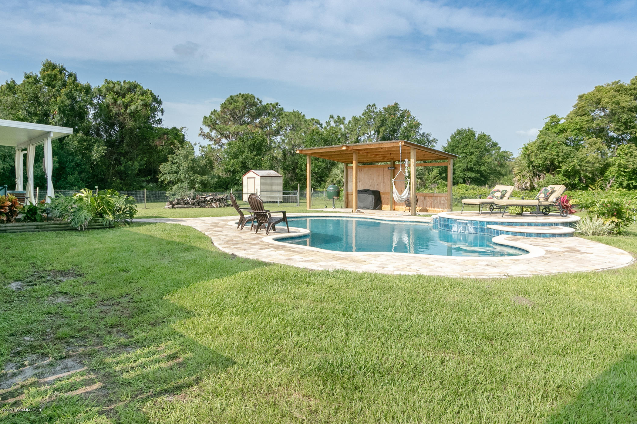 1760 Corey Road Malabar, FL 32950 - Photo 31 of 39 a front view of a house with garden and trees