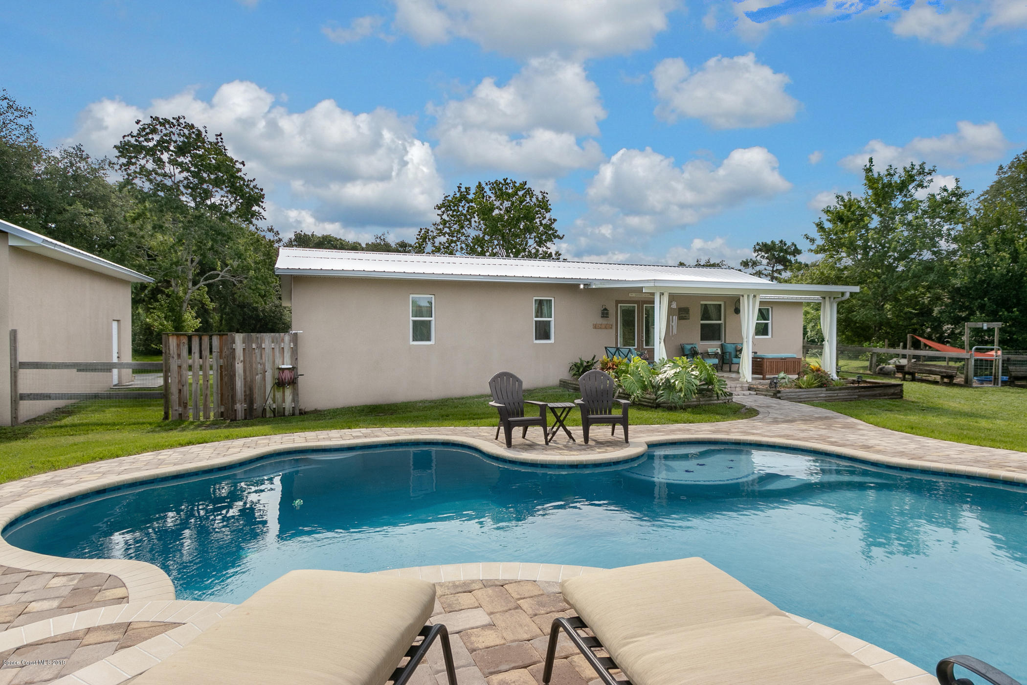 1760 Corey Road Malabar, FL 32950 - Photo 33 of 39 a view of a house with swimming pool and sitting area