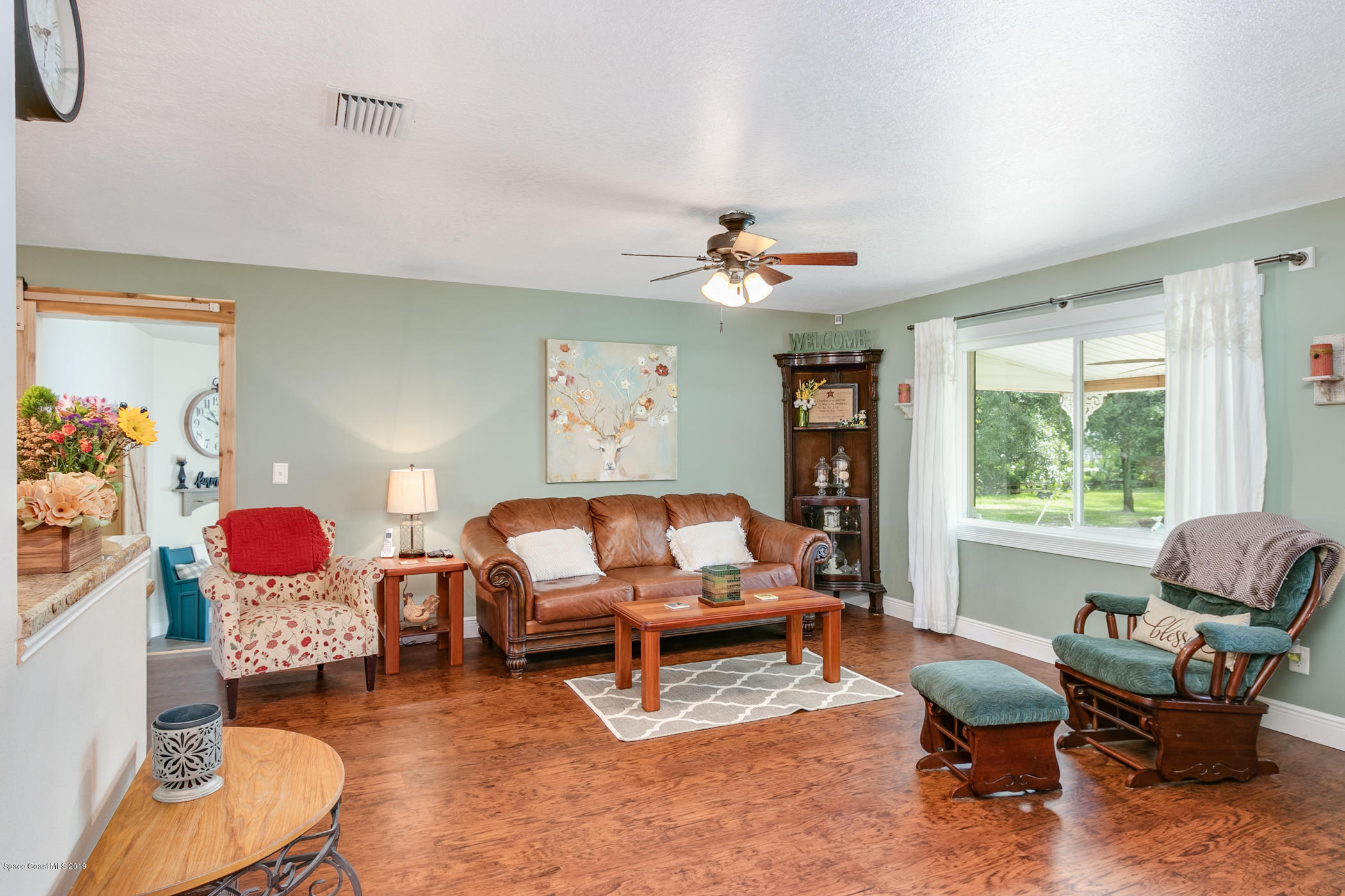1760 Corey Road Malabar, FL 32950 - Photo 7 of 39 a living room with furniture and a large window