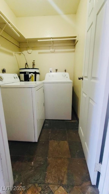 6935 Kepler Drive, Unit D Las Vegas, NV 89156 - Photo 11 of 11 Washroom featuring water heater and washer and clothes dryer