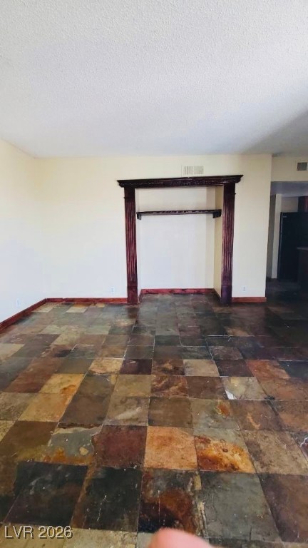 6935 Kepler Drive, Unit D Las Vegas, NV 89156 - Photo 6 of 11 Unfurnished room featuring baseboards and a textured ceiling