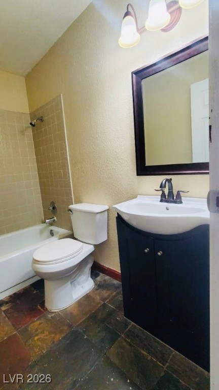 6935 Kepler Drive, Unit D Las Vegas, NV 89156 - Photo 8 of 11 Full bath with vanity, shower / tub combination, a textured wall, and stone tile flooring