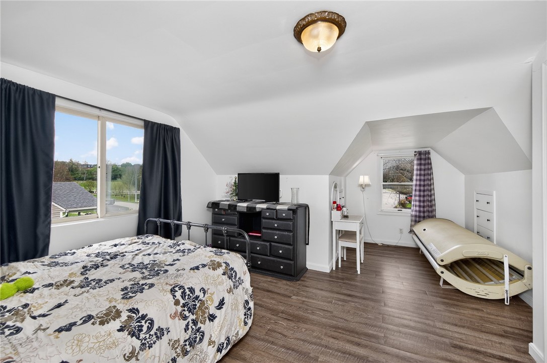 3301 Wildwood Road Middletown, OH 45042 - Photo 28 of 68 This cozy bedroom offers sloped ceilings, ample natural light, and durable laminate flooring.