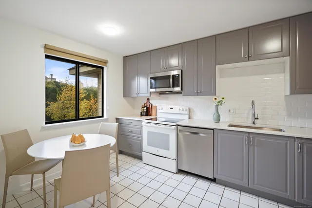 a kitchen with a sink stove and microwave