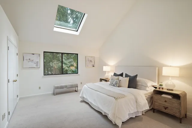 a bedroom with a bed and a night stand