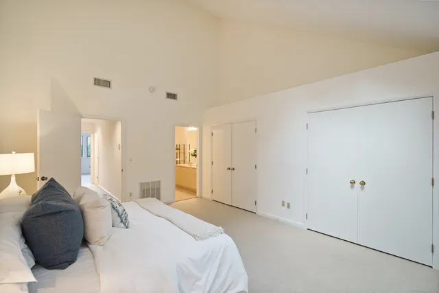 a bedroom with a bed and a painting on the wall