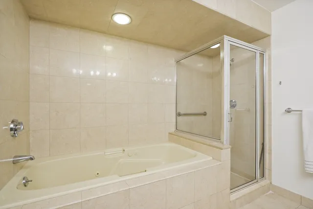 a bathroom with a bathtub and a shower