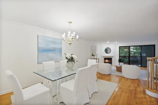 a view of a dining room with furniture wooden floor and chandelier