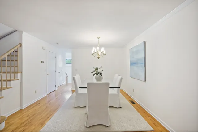 a view of a dining room with furniture and a window