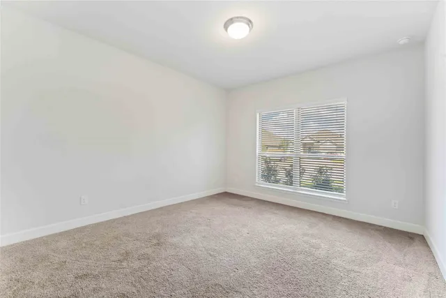 a view of an empty room with windows