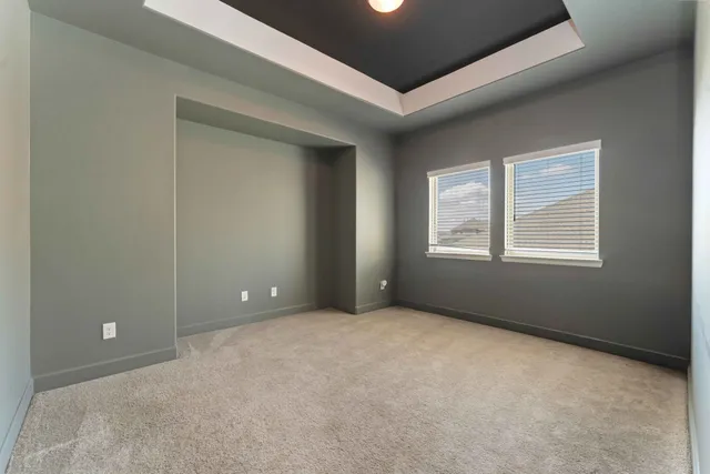 a view of a livingroom with a chandelier fan and a window