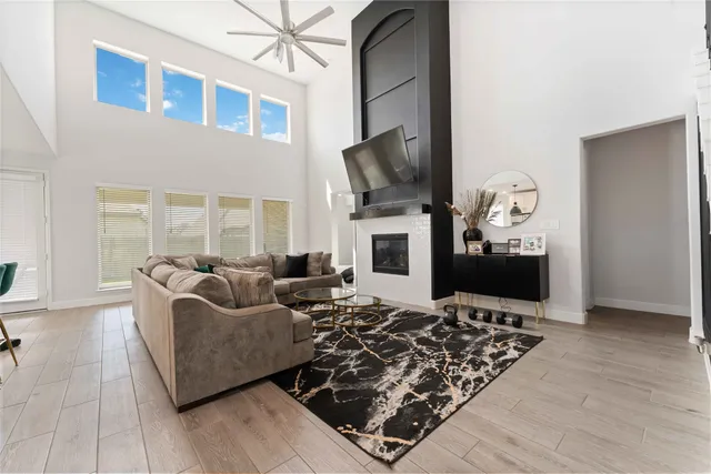 a living room with fireplace furniture and a flat screen tv