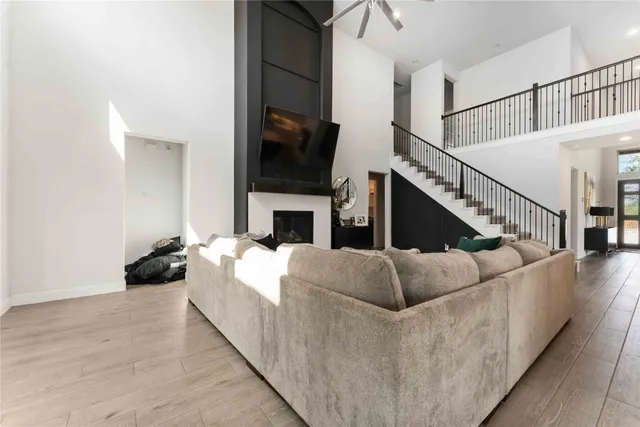 a living room with fireplace furniture and a flat screen tv