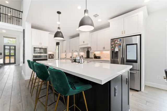 a kitchen with sink and cabinets