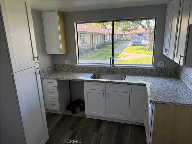 a bathroom with a sink a vanity and a window