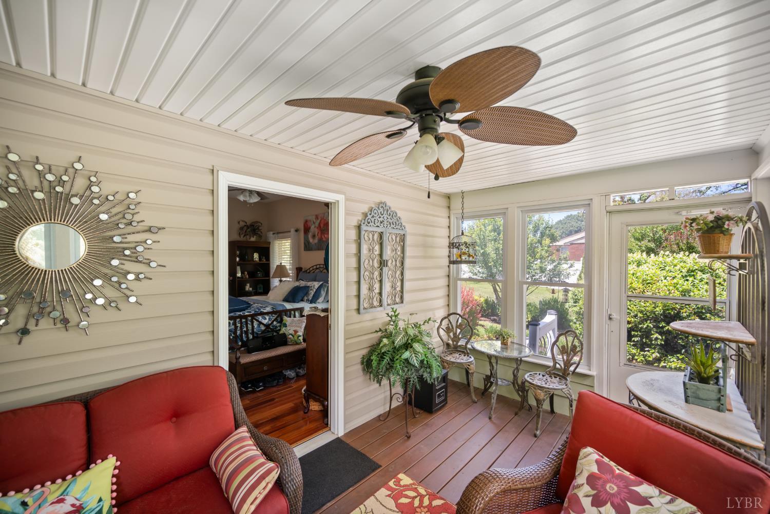 232 Elon Road Madison Heights, VA 24572 - Photo 18 of 65 Walk out of the primary bedroom into this charming garden room filled with natural light and views of a beautifully landscaped backyard.