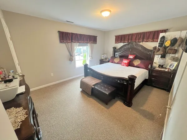 a bedroom with a bed and window