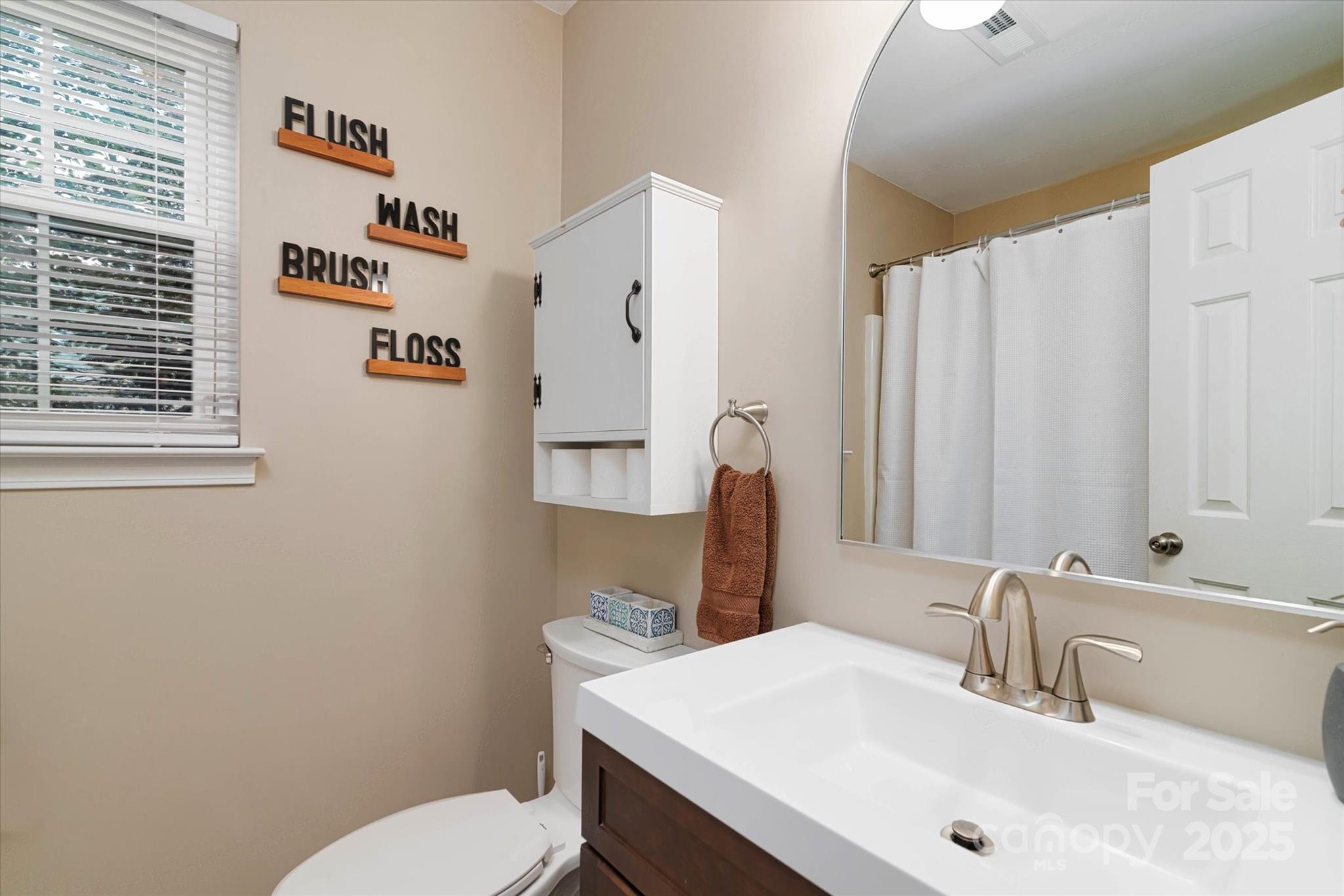 1216 Stevens Road Monroe, NC 28110 - Photo 13 of 40 a bathroom with a sink a toilet and mirror