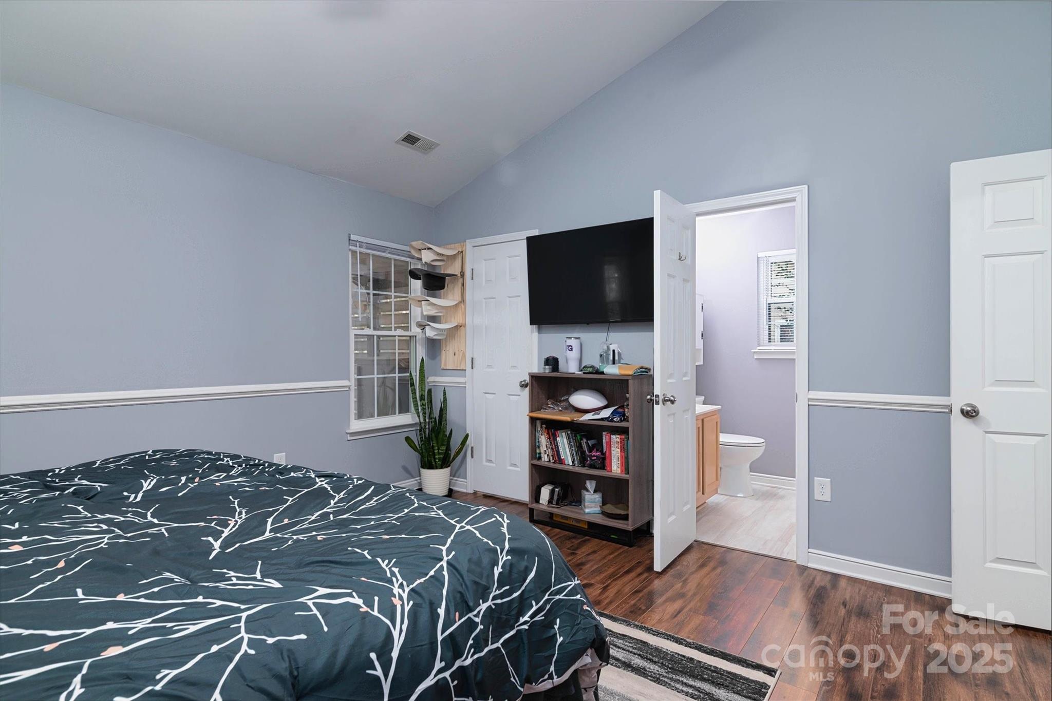 1216 Stevens Road Monroe, NC 28110 - Photo 19 of 40 a bedroom with a bed and a flat screen tv