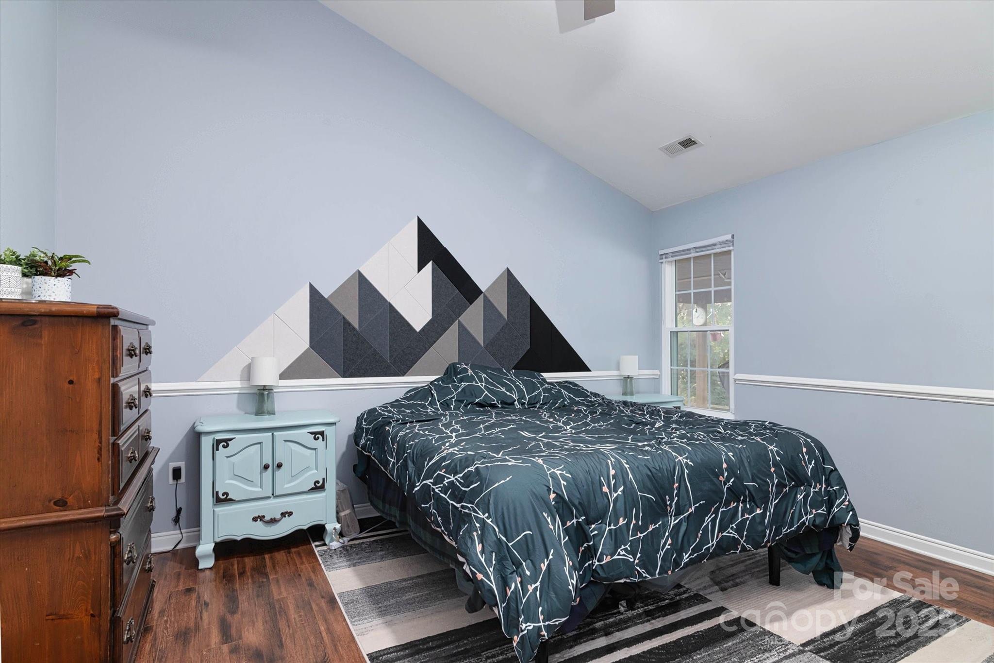 1216 Stevens Road Monroe, NC 28110 - Photo 22 of 40 a bedroom with a bed and wooden floor