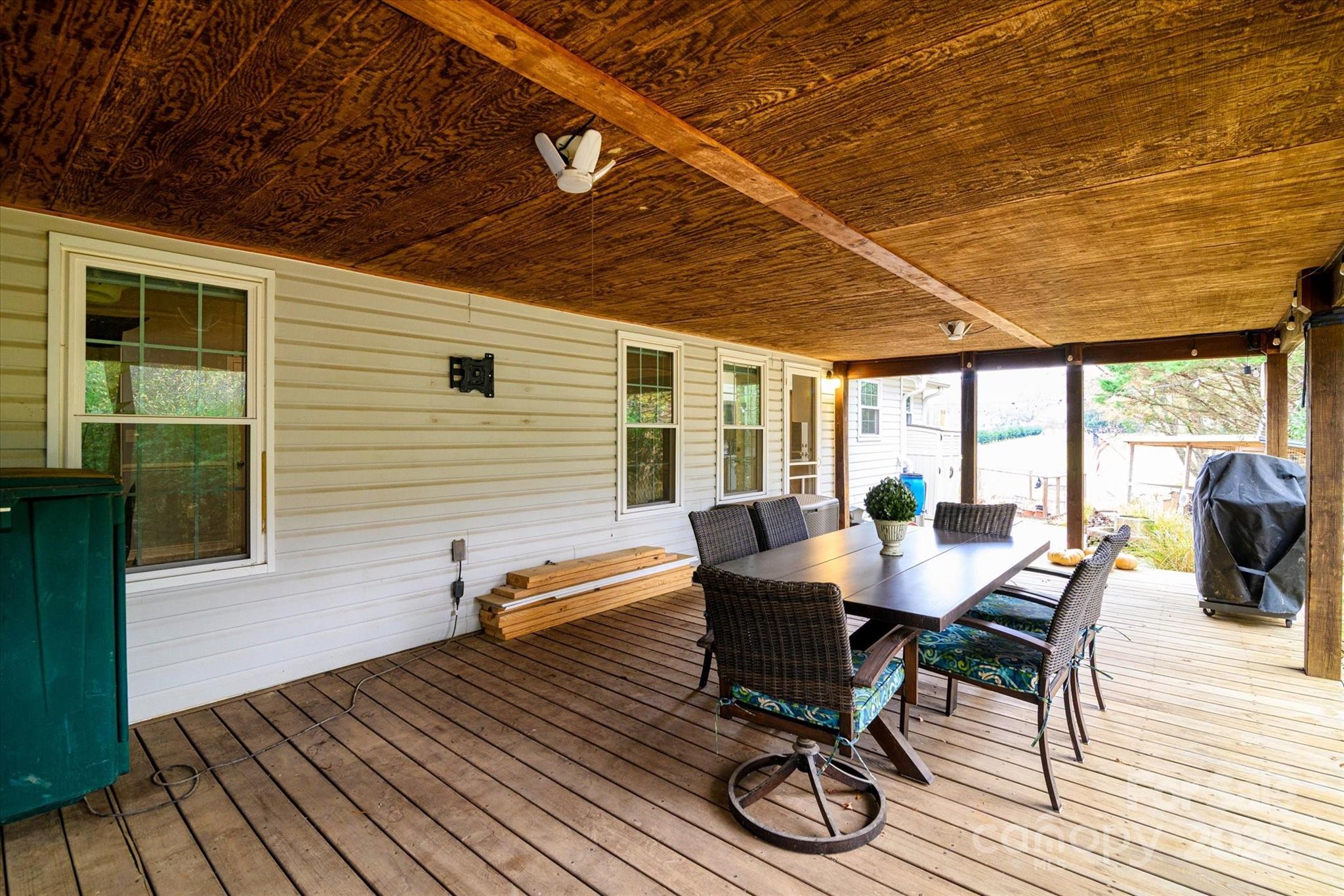 1216 Stevens Road Monroe, NC 28110 - Photo 26 of 40 a view of a dining room with wooden floor and outdoor seating