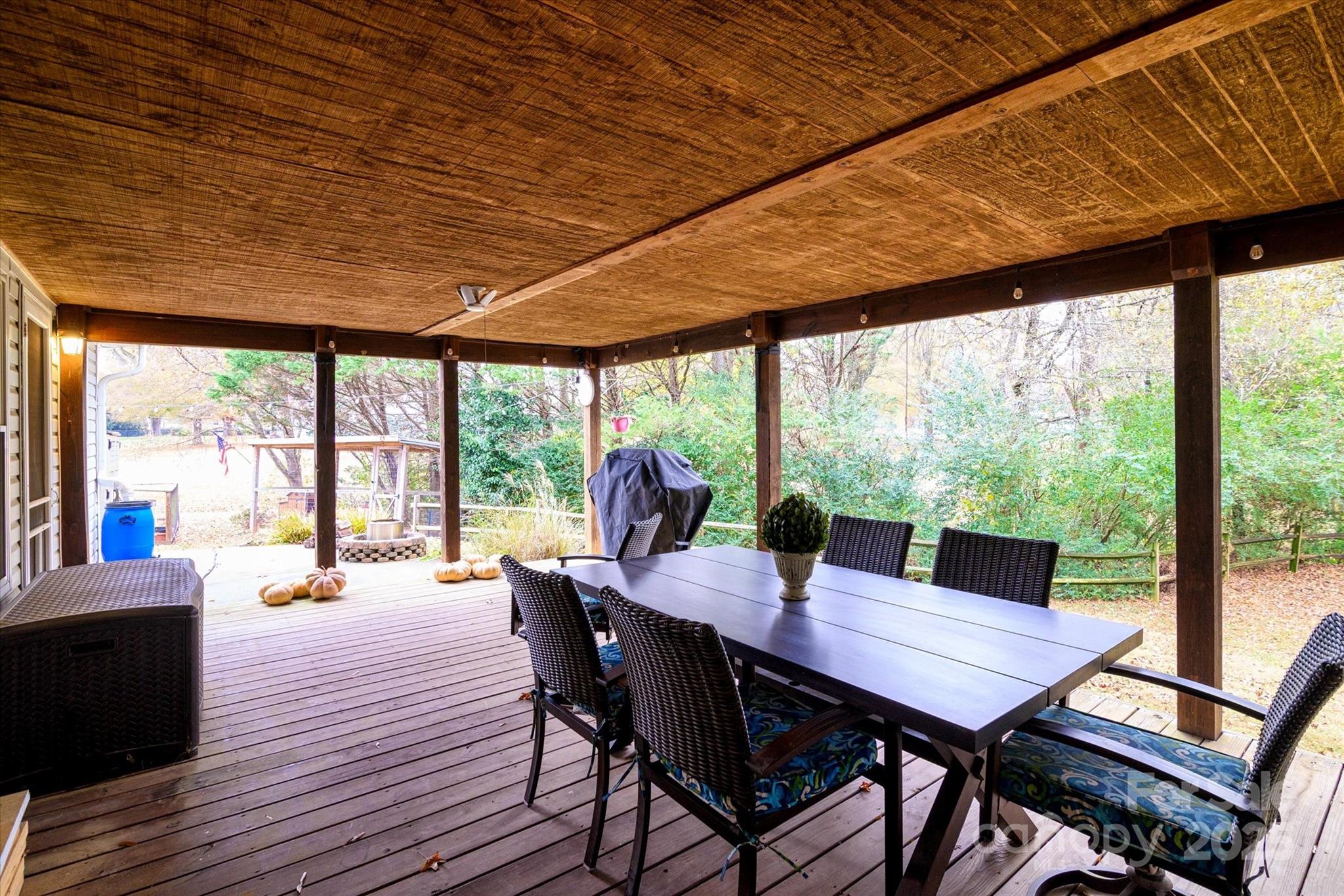 1216 Stevens Road Monroe, NC 28110 - Photo 27 of 40 a view of a dining room with furniture large windows and wooden floor