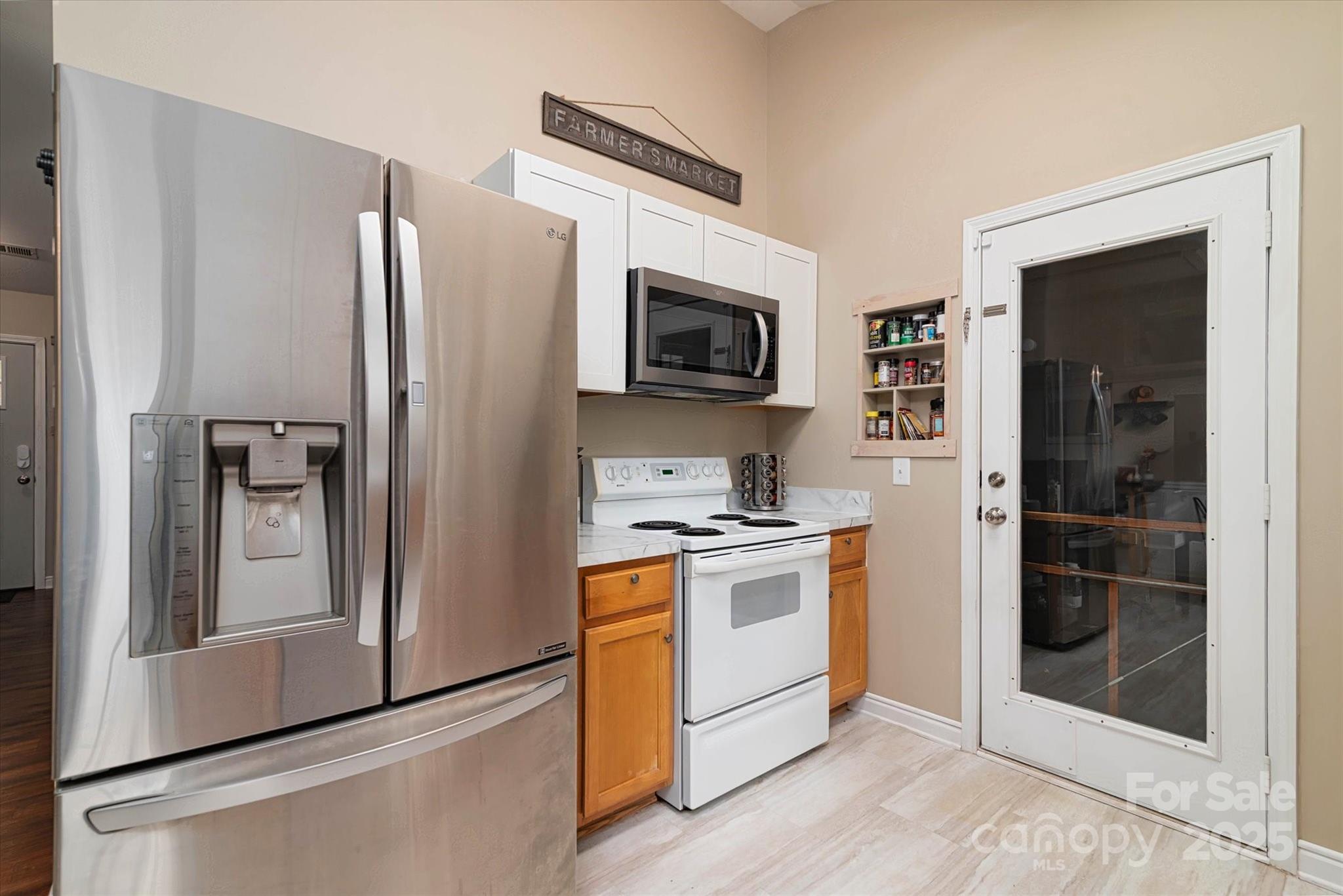 1216 Stevens Road Monroe, NC 28110 - Photo 9 of 40 a kitchen with stainless steel appliances granite countertop a refrigerator stove and sink