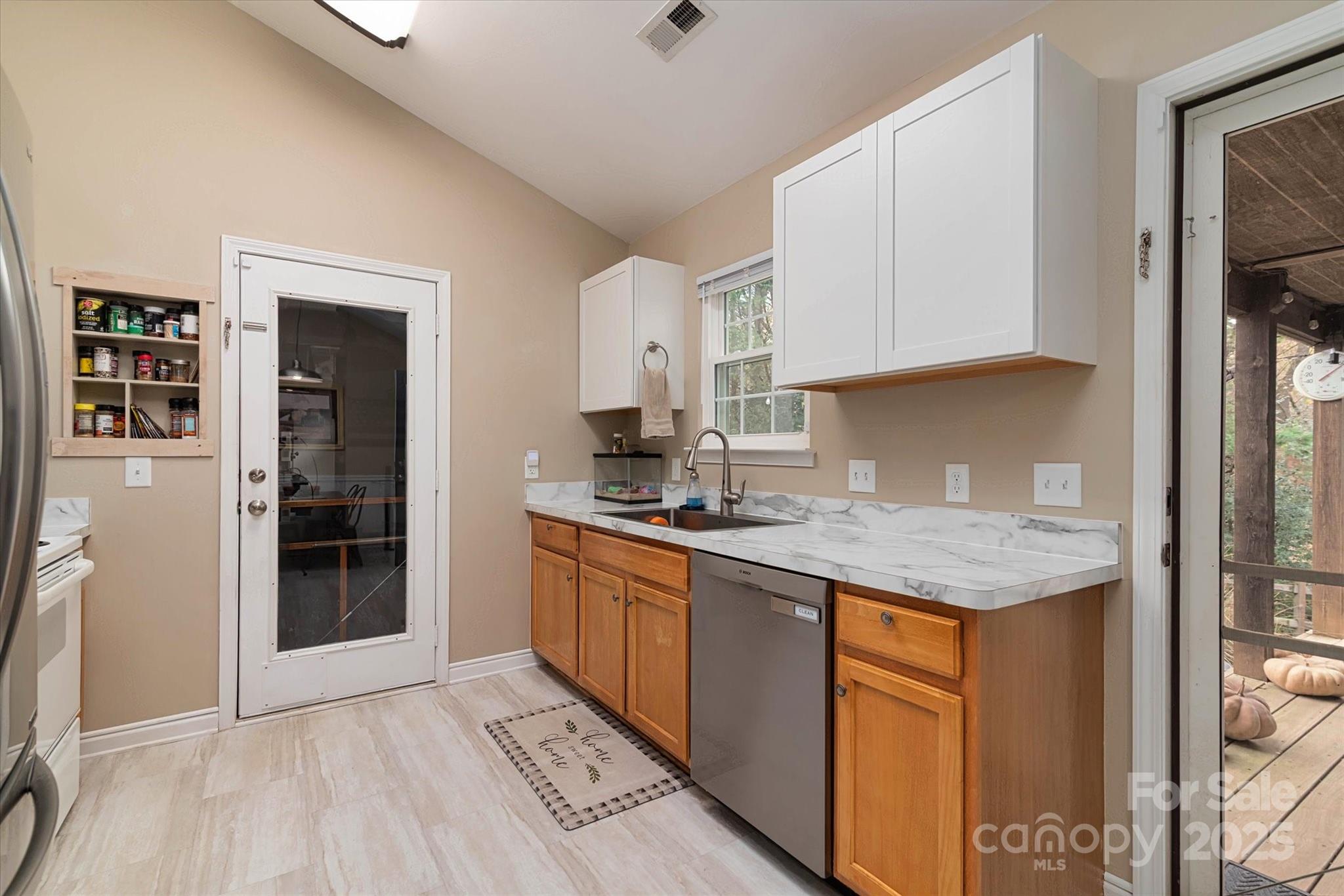 1216 Stevens Road Monroe, NC 28110 - Photo 10 of 40 a kitchen with granite countertop a sink stove and cabinets